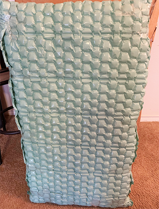 Large box wrapped in protective bubble wrap.
